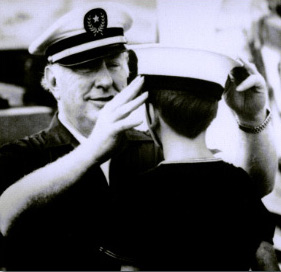 LRH adjusting a sailor's hat
